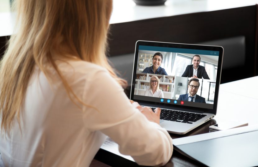 Back,View,Of,Businesswoman,Speak,Using,Webcam,Conference,On,Laptop